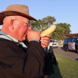 Teacher George Dugal blows his cow horn Thursday nght.